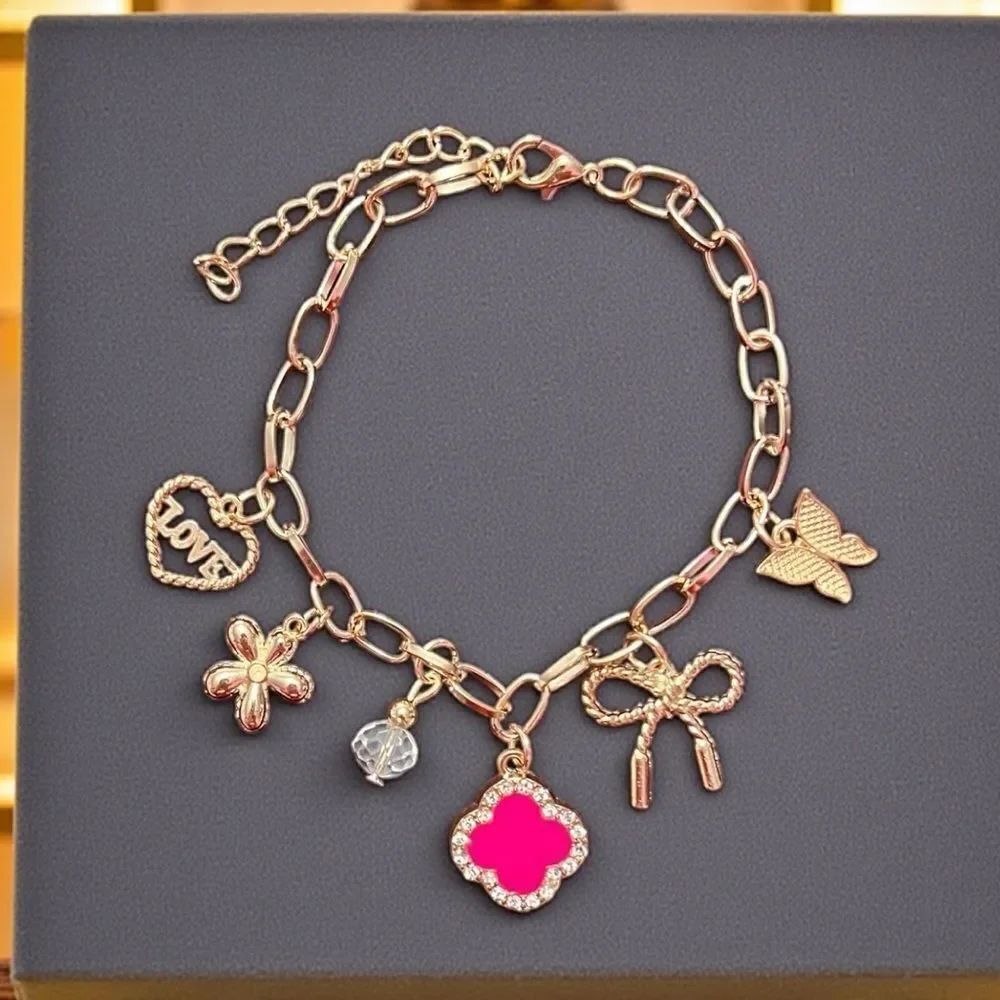 Gold Tone Bracelet with Pink Clover Heart Bow Butterfly And Flower Charm